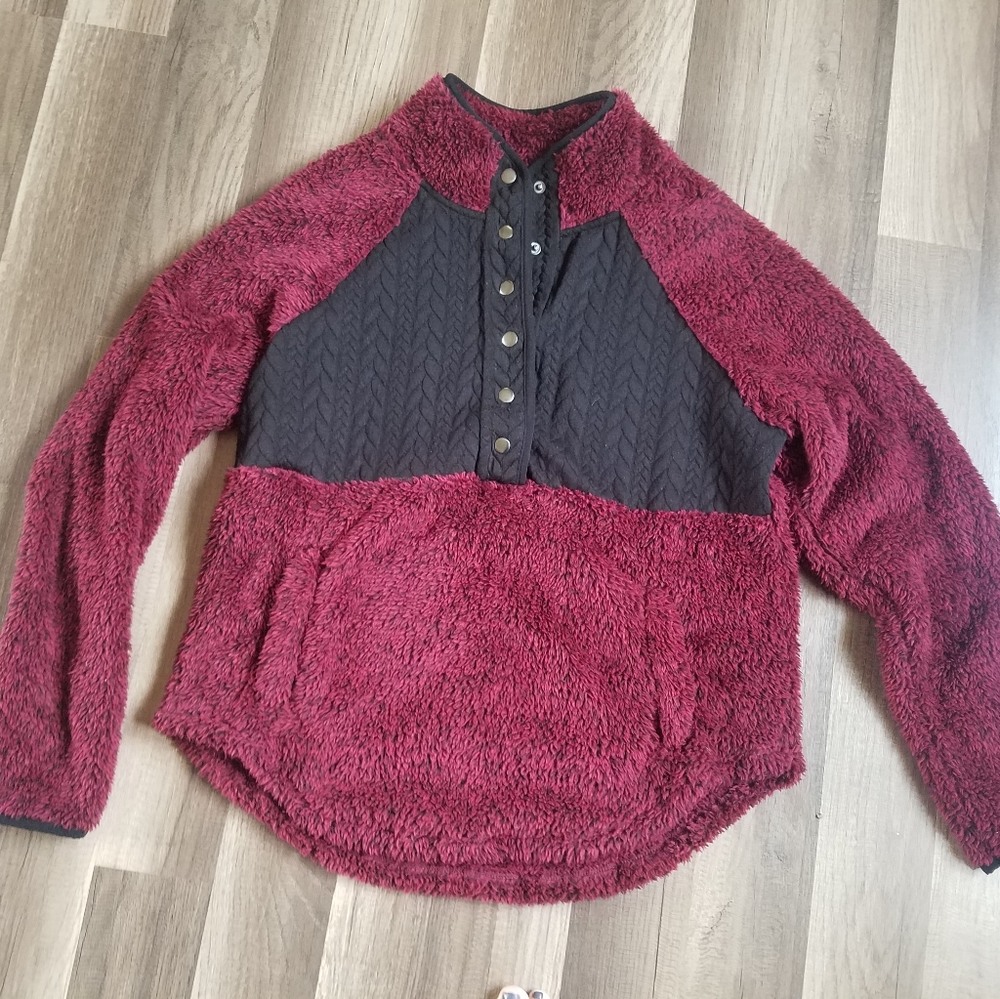 Plum colored pullover.